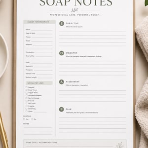 May include: A white massage therapy SOAP notes form on a clipboard. The document includes sections for client information, modalities used, and the SOAP framework: Subjective, Objective, Assessment, and Plan, with lines for writing and a signature line.