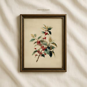 May include: A framed botanical print featuring a branch with red berries and green leaves. The artwork is set against a cream-colored background and framed in a dark, ornate gold frame. The text "VINTAGE GLOW PRINTS" is at the top.