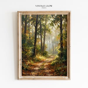 May include: A framed landscape painting of a forest path. The artwork features tall trees with green and yellow foliage, a path covered in fallen leaves, and the text "VINTAGE GLOW PRINTS" at the top.