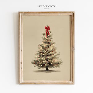 May include: A framed wall art print featuring a green Christmas tree on a beige background. The tree is decorated with small white lights and red ornaments, topped with a large red bow. The text VINTAGE GLOW PRINTS is centered at the top.