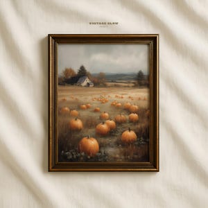 May include: Framed autumn landscape print featuring a field of pumpkins. The artwork depicts a farm scene with a barn, trees, and a cloudy sky. The print is in a gold-colored frame, with the text "VINTAGE GLOW PRINTS" at the top.