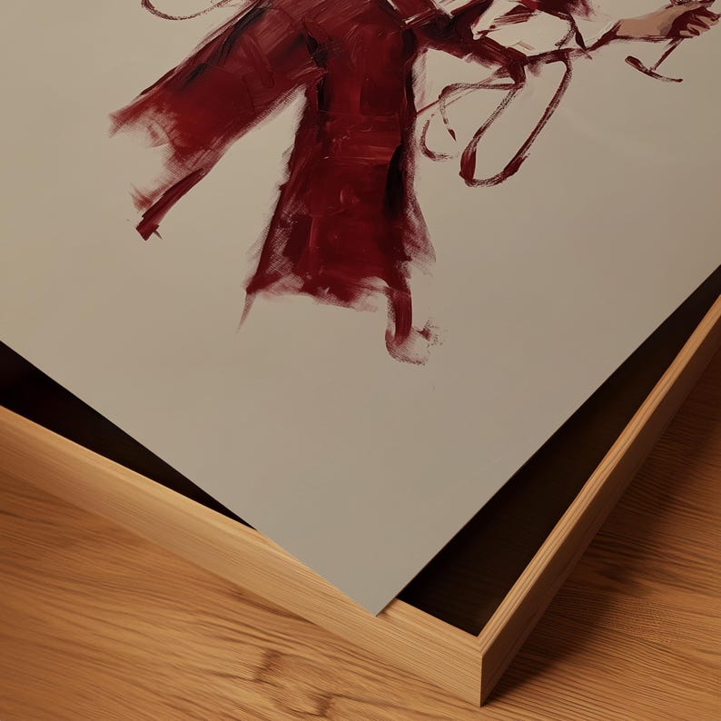 Puede incluir: Pintura abstracta en un marco de madera. La obra presenta audaces pinceladas de color rojo intenso sobre un fondo neutro. El marco es de color madera clara, lo que a&ntilde;ade un contraste natural a los tonos vibrantes de la pintura. Es una obra de arte moderna.