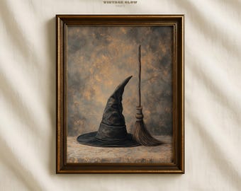 May include: A framed print featuring a black witch's hat and a broom against a mottled brown and gray background. The print is framed in a dark brown wooden frame. The text "VINTAGE GLOW PRINTS" is at the top.
