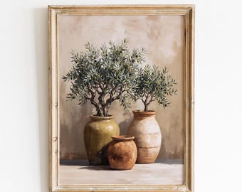 May include: A framed wall art print titled VINTAGE GLOW PRINTS featuring an oil painting of two olive trees in three terracotta and ceramic pots. The trees have green leaves and small dark olives, set against a neutral beige textured background.