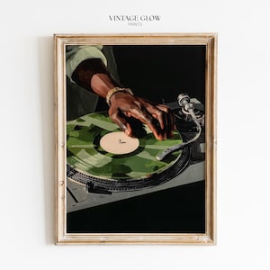 May include: Framed print of a DJ's hand on a turntable with a green camouflage record. The image has a dark background and the text "VINTAGE GLOW PRINTS" at the top.