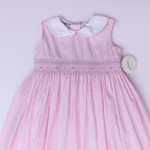Hand‑embroidered girls smock dress. Pink spring dress with blue hand embroidered flowers.