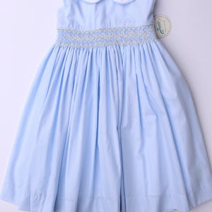 Smocked hand embroidered girls dress -Baby blue sleeveless dress with a collar, yellow flower embroidery, and a bow on the back.