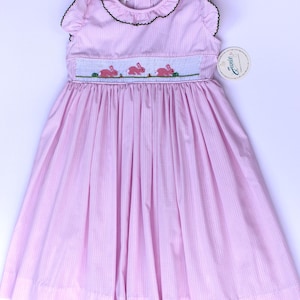 Hand‑embroidered smock Easter girls dress. Pink spring dress with embroidered bunnies and ruffled sleeves