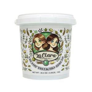 May include: A white plastic container with a green lid, filled with creamy pistachio spread. The container has a colorful label with the text "La Clara Perla Creamy Pistachio Spread" and a net weight of 35.3 oz (2.20 lb) 1 kg.