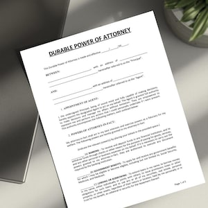 May include: A white document titled "Durable Power of Attorney" with black text. The document includes sections for appointing an agent and outlining powers. The paper is on a light-coloured surface.