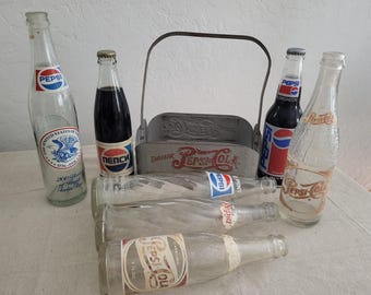 Vintage Pepsi Bottle Collection with Metal Carrier – 7 Bottles Including USSR & Bicentennial Editions