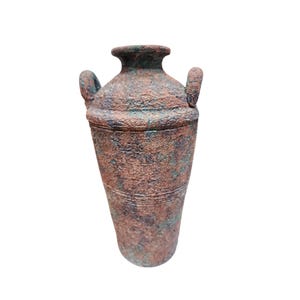 May include: A terracotta vase with two handles and a textured surface. The vase is a muted brown color with hints of green and red.