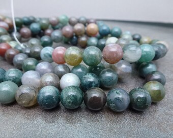 May include: A strand of green, brown, and pink agate beads. The beads are round and have a smooth, polished finish.