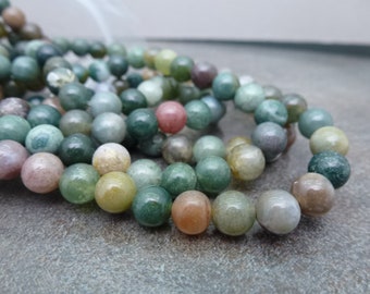 May include: A strand of round, green, brown, and pink agate beads. The beads are smooth and polished, with a natural, mottled appearance.