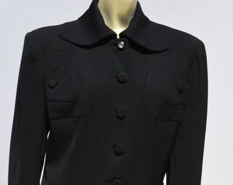 May include: A black blazer with a collar and five buttons. The blazer has two large pockets on the front and two smaller pockets on the chest.