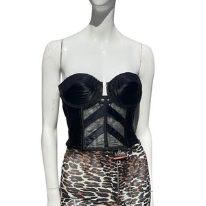 May include: Black satin strapless corset with a black mesh overlay and a leopard print spandex short.