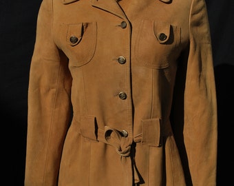 May include: A brown suede jacket with a belt and pockets. The jacket has a button closure and a collar.