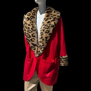 May include: A red robe with a leopard print fur collar and cuffs. The robe is made of a soft, luxurious fabric and has a classic, elegant design.