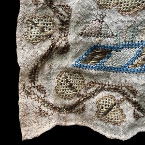 May include: A white ceramic mug with a black handle and the text "But First, Coffee" in a black, handwritten-style font. The mug is on a white surface.