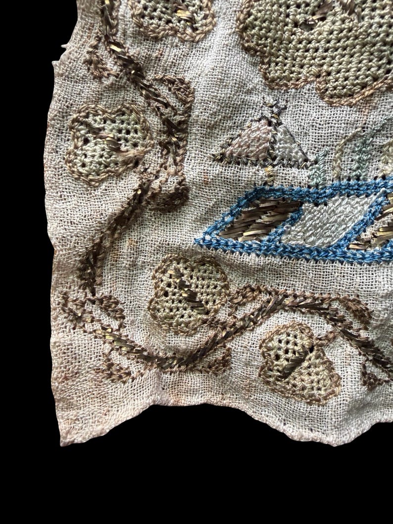 May include: A white ceramic mug with a black handle and the text "But First, Coffee" in a black, handwritten-style font. The mug is on a white surface.