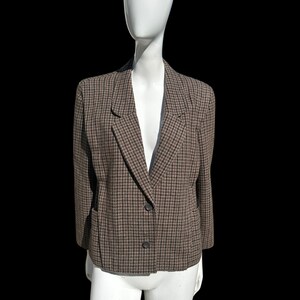 May include: A brown and black houndstooth patterned blazer with a single button closure.