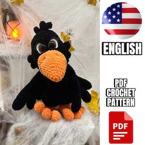 Può includere: Un corvo all'uncinetto nero con un grande becco arancione testurizzato e zampe arancioni. L'uccello presenta occhi neri rotondi prominenti con accenti bianchi. Il testo PDF CROCHET PATTERN è visualizzato in lettere maiuscole nere accanto a un'icona PDF rossa.