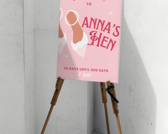 Puede incluir: Un cartel de bienvenida rosa con el texto "Bienvenido a Anna's Hen 20 días hasta que diga que sí!" y un par de tacones blancos con correas rosas.