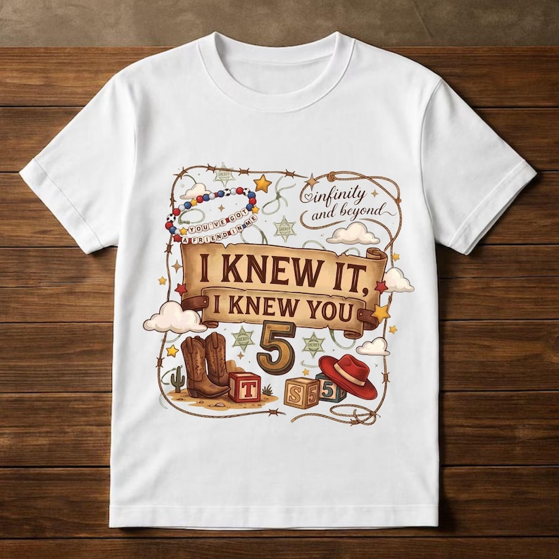 May include: A white short-sleeve t-shirt featuring a graphic print with a scroll banner that reads I KNEW IT, I KNEW YOU, the number 5, a red cowboy hat, brown cowboy boots, alphabet blocks, a beaded necklace, and the text infinity and beyond.