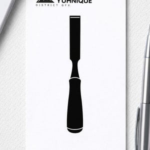 May include: A black and white graphic of a chisel tool on a white background. The image includes the text "YUHNIQUE DISTRICT GFX" and "PNG SVG DOWNLOADS". A silver pen and a smartphone are in the background.