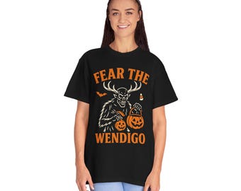 May include: Black t-shirt with the text "FEAR THE WENDIGO" in orange. The graphic features a skeletal creature with antlers holding two jack-o'-lanterns. A bat and candy corn are also included in the design.