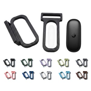 May include: A set of black 3D-printed plastic clips and a black oval remote control. The clips feature a rectangular loop design with a side-mounted attachment point. Below, ten pairs of these clips are displayed in various colors including black, green, lavender, light green, dark gray, pink, blue, white, light blue, and brown.