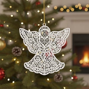 May include: A white, intricately designed angel Christmas ornament. The ornament is suspended by a gold string and features detailed cut-out patterns. It is hanging on a Christmas tree with other ornaments and lights.