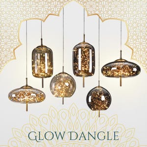May include: Six pendant lights with various glass shapes, including oval, round, and rectangular, each filled with tiny, warm white lights. The lights hang from thin wires against a white background with gold decorative elements. The text "GLOW DANGLE" is at the bottom.