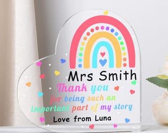 May include: A clear acrylic heart-shaped plaque with a rainbow design and the text "Mrs Smith Thank you for being such an important part of my story Love from Luna". The plaque has colorful heart accents.