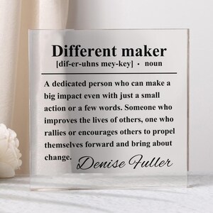 May include: A transparent acrylic block featuring the text "Different maker" and its definition. The definition describes someone who makes a big impact. The name "Denise Fuller" is signed at the bottom of the block.