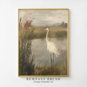 May include: A vintage painting depicting a white crane standing in a marsh with tall reeds. The crane has a long neck and a red spot on its head. The background is a soft, muted blue and green.