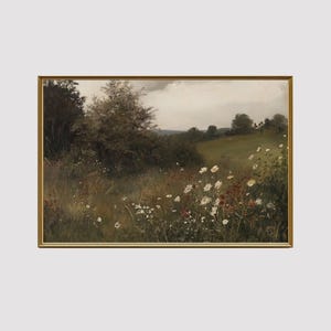 May include: A framed landscape painting depicts a field of wildflowers in a meadow. The artwork features a gold frame and a serene scene with daisies, tall grass, and a cloudy sky. The color palette includes greens, browns, and whites.