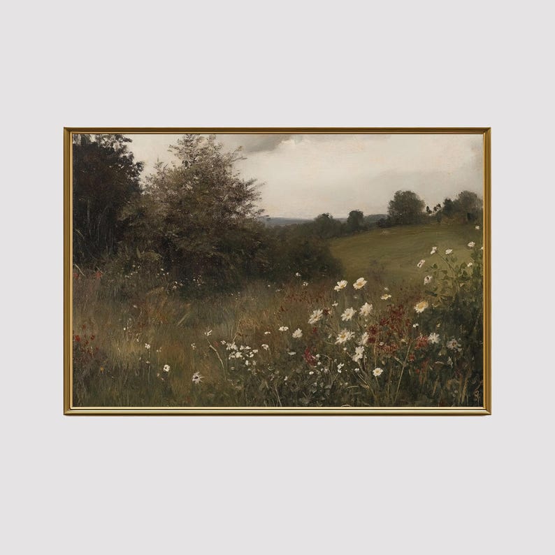 May include: A framed landscape painting depicts a field of wildflowers in a meadow. The artwork features a gold frame and a serene scene with daisies, tall grass, and a cloudy sky. The color palette includes greens, browns, and whites.