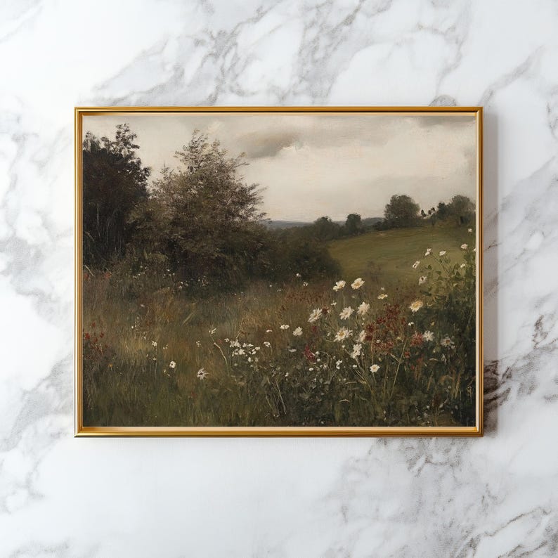 May include: A framed landscape painting featuring a field of wildflowers and trees under a cloudy sky. The artwork has a gold frame and a vintage aesthetic. The color palette includes greens, browns, and whites.