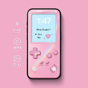 May include: A pink handheld gaming console with a holographic rainbow finish. The screen displays the time 1:47 and the text New Game? with Yes, No, and a heart icon. It features a directional pad, A and B buttons, and Select and Start buttons.