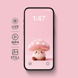 May include: A smartphone displays a pink wallpaper featuring a plush mushroom with a pink and white spotted cap and a smiling face. The time 1:47 is displayed at the top. Icons for live, MP4, and still wallpapers are on the left.