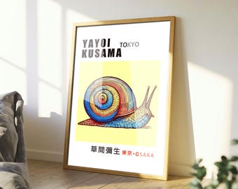 May include: A framed art print featuring a colorful illustration of a snail with a rainbow-colored shell. The print includes the text "YAYOI KUSAMA TOKYO" and Japanese text. The artwork is set against a yellow background.