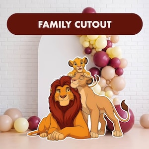 May include: A cardboard cutout featuring a cartoon lion family with a male lion, a female lion, and a cub. The male lion has a dark red mane, the female lion is tan, and the cub is light orange. The text FAMILY CUTOUT is printed at the top.