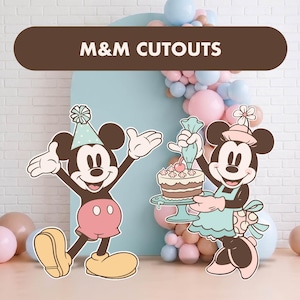 May include: Two character cutouts featuring a black and white mouse wearing a blue party hat and pink shorts, and a mouse wearing a pink hat and light blue apron holding a cake with a piping bag. The text M&M CUTOUTS appears in a brown banner.