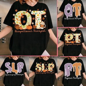May include: Black t-shirts with various designs for occupational therapists, physical therapists, and speech-language pathologists. The designs feature the initials "OT", "PT", and "SLP" with fall-themed graphics, including leaves, pumpkins, and coffee cups. The words "Occupational Therapist", "Physical Therapist", and "Speech-language Pathologist" are also included.