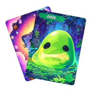 May include: Two fantasy art cards. One card features a green, blob-like creature with the word "OOZE" in a green banner. The other card has a cat-like character with a colorful background. Both cards have the text "PAW PRINT PROXY".