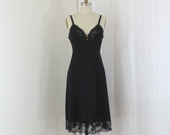 Vintage Black Full Slip, Bust is trimmed with Lace  Lined with Sheer Chiffon,   4 Inch Wide  Lace on the  Hem  Circa 1950s