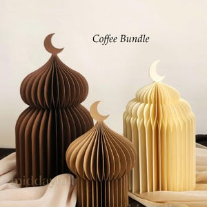 May include: Three paper mosque-shaped decorations in varying sizes and colours: dark brown, light brown, and cream. Each has a crescent moon on top. The text "Coffee Bundle" is visible.