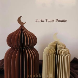 May include: Two paper sculptures in earth tones, resembling domed structures, are displayed. One is a deep brown, the other a light beige. Each has a crescent moon on top. The text "Earth Tones Bundle" is visible.