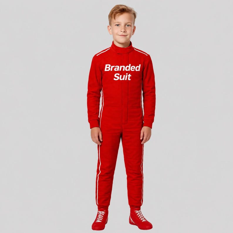 May include: A bright red racing jumpsuit featuring a high collar, long sleeves, and white vertical piping along the sides. The chest area displays the white text Branded Suit. The garment is paired with matching red lace-up athletic shoes.
